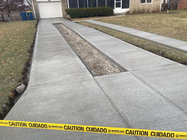 Long driveway, freshly finished, taped off in Carmel, Indiana